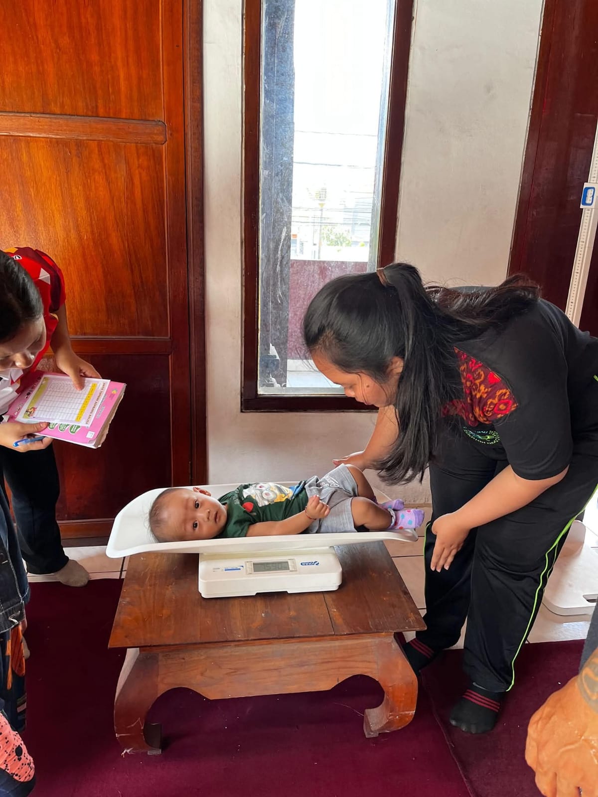 posyandu balita yang dirangkaikan dengan pemberian makanan tambahan (PMT) di Abian Kapas Kaja